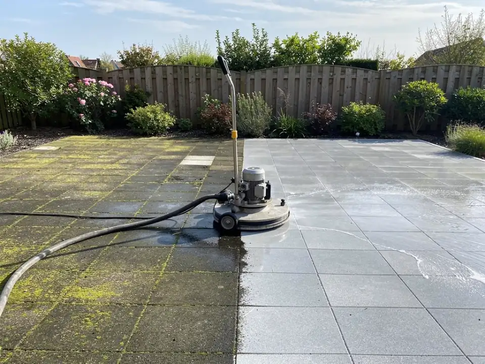 Terras half gereinigd met de oppervlaktereiniger op de grens van vuil en schoon